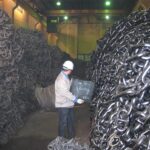 Large anchor chains stored in factory warehouse for inspection