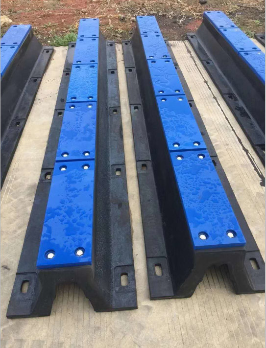 Arch rubber fenders fitted with blue UHMWPE face pads for dock and berth protection
