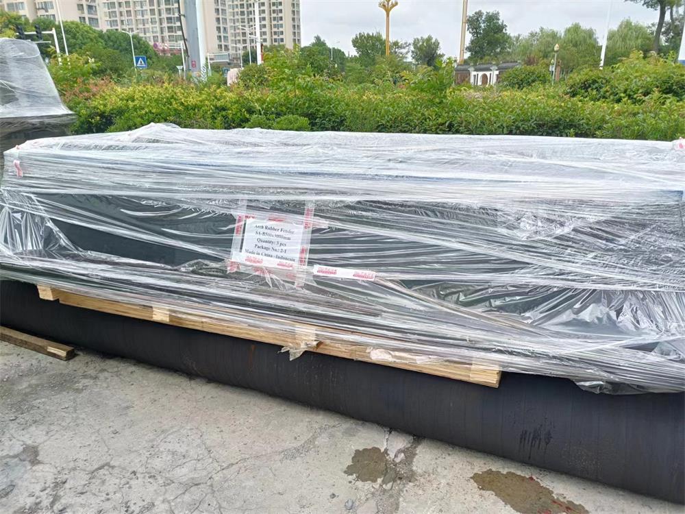 Arch rubber fenders packed on pallets and supporting frames for forklift handling and shipment
