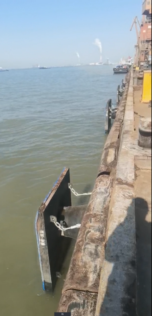Rubber cone fender system installed on port dock berth with frontal panel and chain accessories