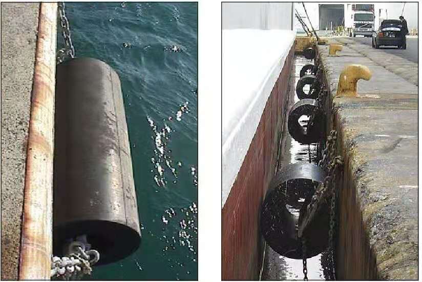 Cylindrical rubber fenders installed on quay walls with chains for dock protection