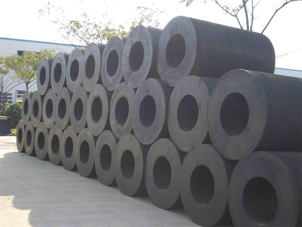 Cylindrical rubber fenders stacked in factory yard for marine dock and berth protection