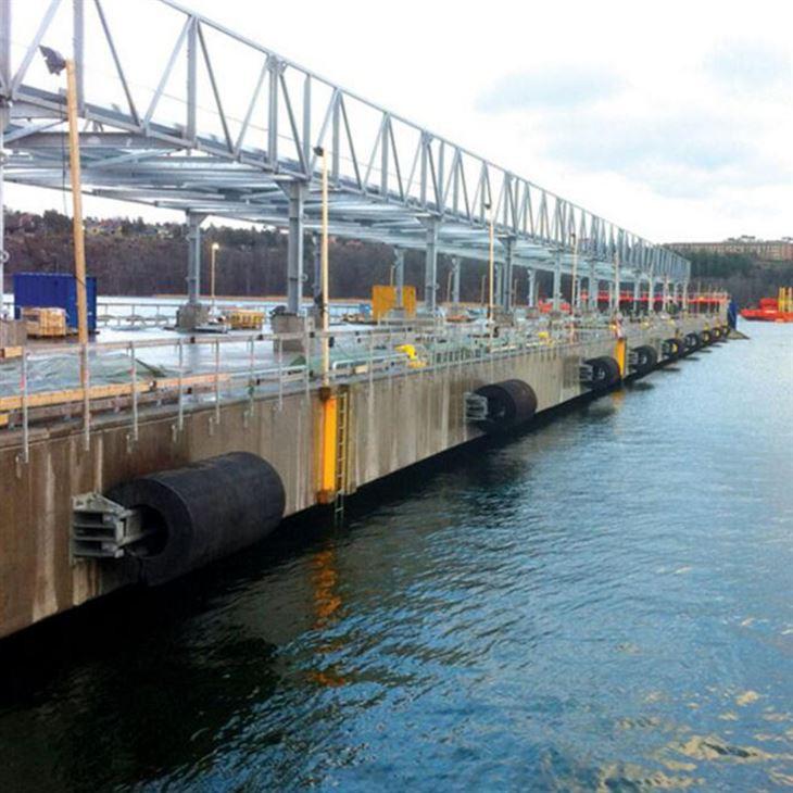 Cylindrical rubber fenders installed along a quay wall for berthing protection