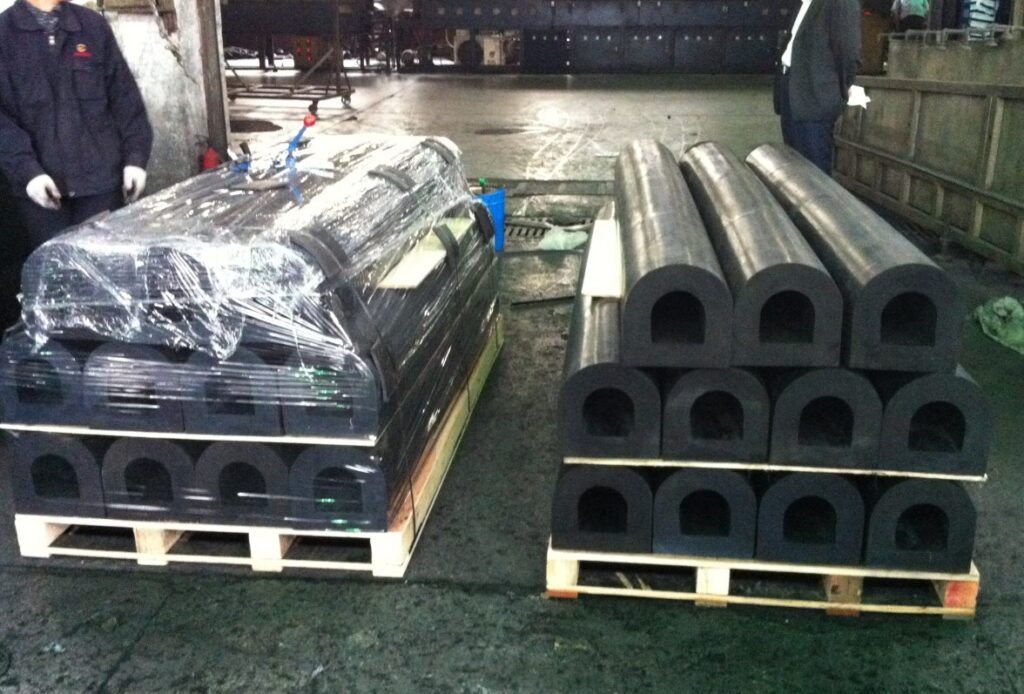 D rubber fenders stacked on pallets and wrapped before shipment
