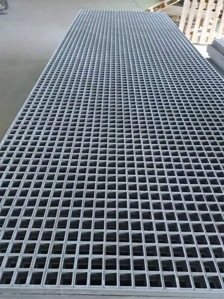 Grey GRP FRP grating panel with open mesh structure for industrial walkway and access flooring applications