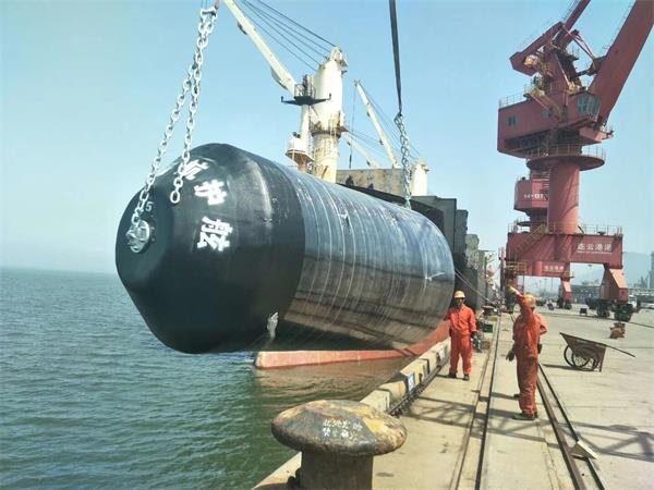 Large foam filled fender being lifted at dock for ship berthing and marine protection