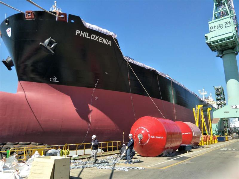 Red foam filled fender used for ship berthing protection at dock