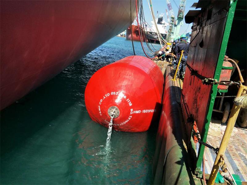 Red foam filled fender used between vessels for ship-to-ship berthing protection