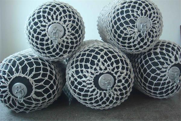 Foam filled fenders with protective rope nets for boat and marine berthing applications
