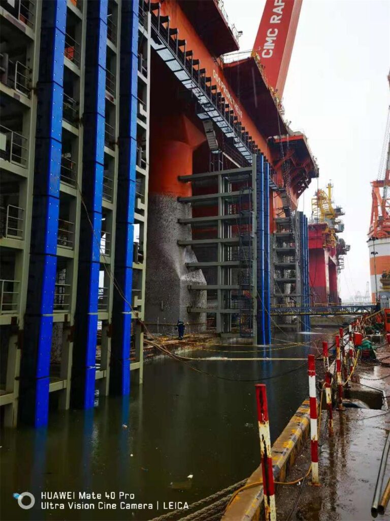 Square rubber fenders with UHMWPE face pads installed on dock structure for vessel protection