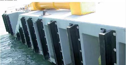 Standard rubber arch fenders installed along a concrete dock for quay wall and berth protection