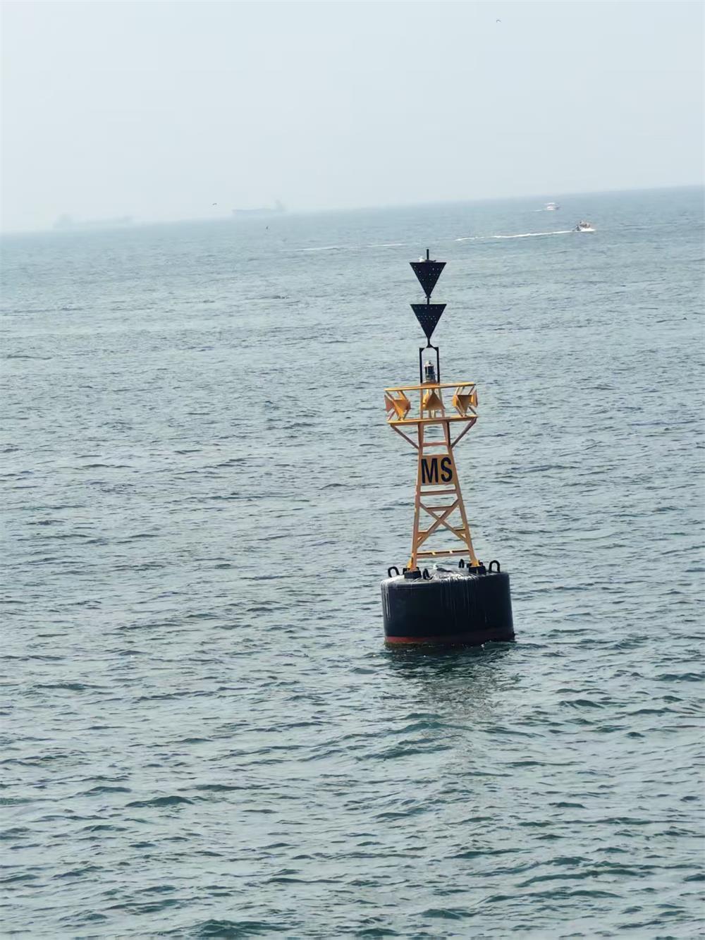 Steel navigation buoy installed at sea for channel marking