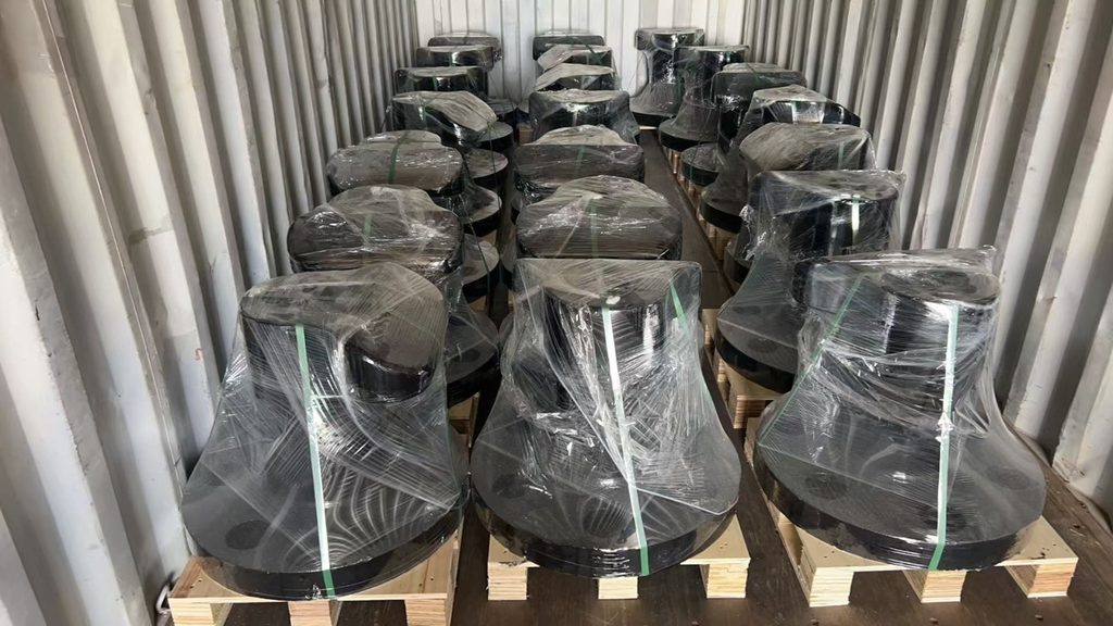 Front view of palletized mooring bollards with clear wrapping and green packing straps