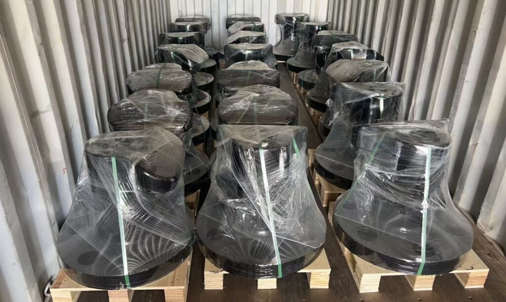Front view of palletized mooring bollards with clear wrapping and green packing straps