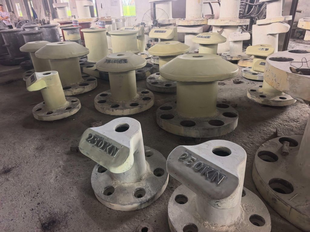 Unpainted 250 kN mooring bollards with cast capacity markings and round mounting bases