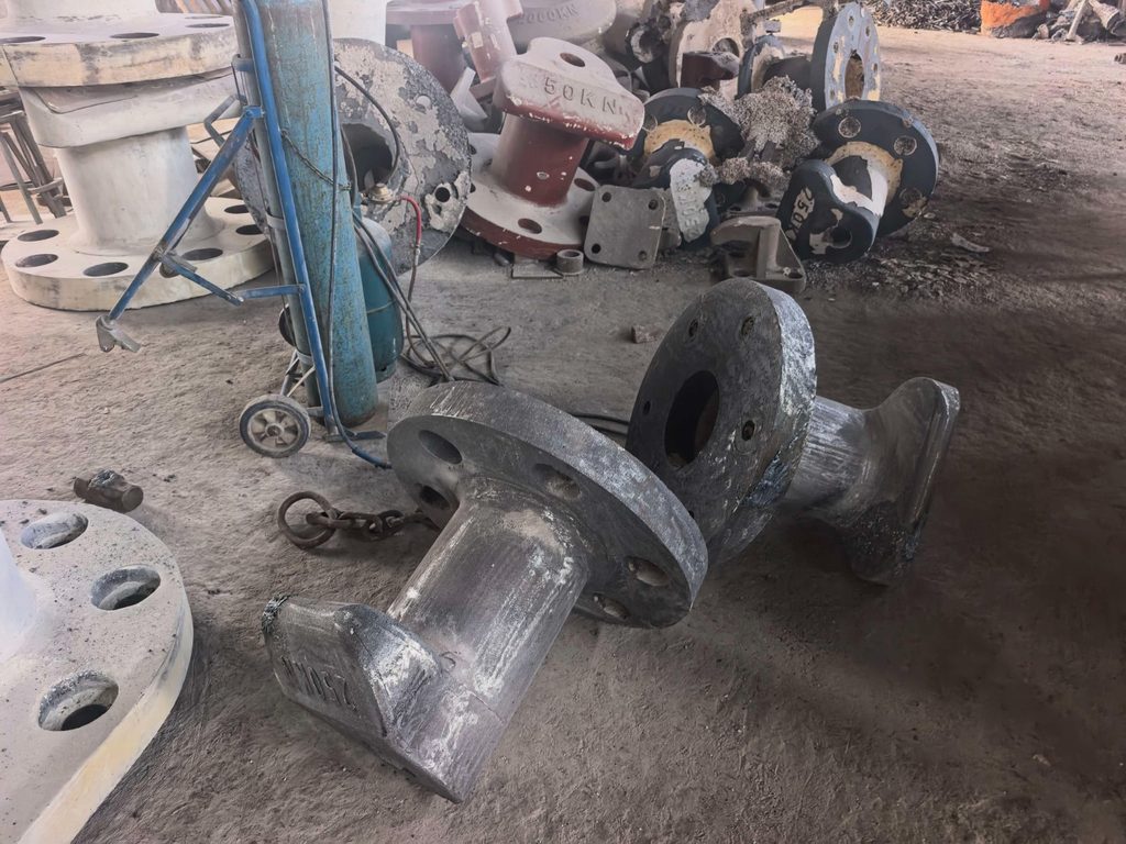 Uncoated mooring bollard castings lying on the factory floor